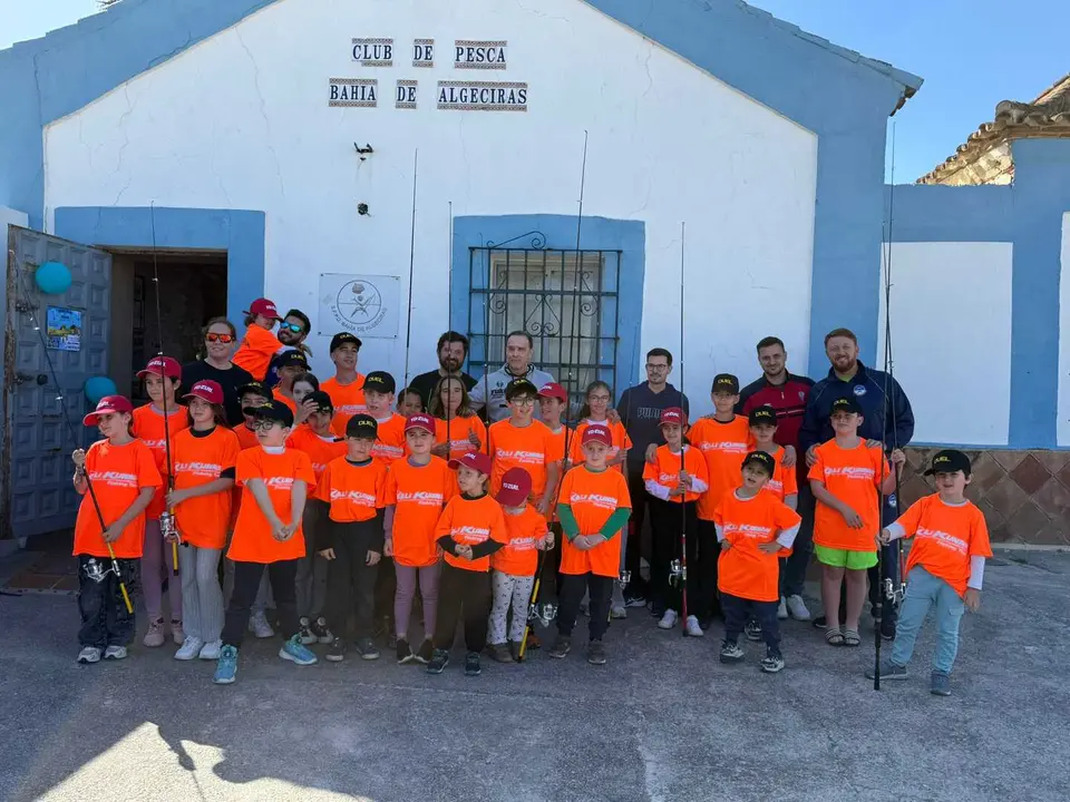 Participantes durante la jornada de la Escuela de Pesca Infantil en la playa de El Rinconcillo.