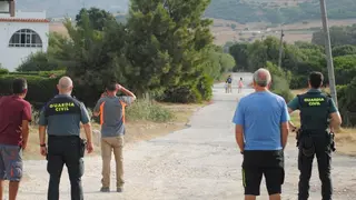 Vecinos de Casa Porros observan las labores contra el fuego junto a agentes de la Guardia Civil 