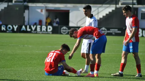 Toca levantarse. El rojiblanco Neco recibe la mano de Merch&aacute;n para ponerse de pie tras una ca&iacute;da.