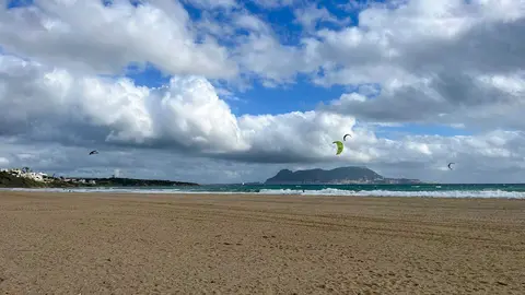 Vista de la playa de Getares con el litoral y el Estrecho al fondo en una jornada con viento y oleaje